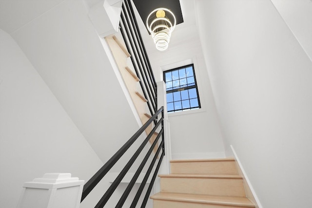 4153 N Hermitage Ave, Chicago, IL 60613 - stairs with baseboards and a chandelier
