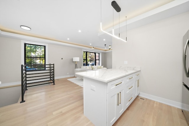 4153 N Hermitage Ave, Chicago, IL 60613 - kitchen featuring a peninsula, white cabinetry, light stone countertops, light wood-style floors, and recessed lighting