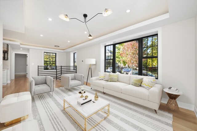 4153 N Hermitage Ave, Chicago, IL 60613 - living room featuring a tray ceiling, light wood-style floors, baseboards, and recessed lighting