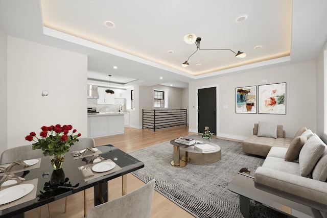 4153 N Hermitage Ave, Chicago, IL 60613 - living room with a tray ceiling and light wood finished floors