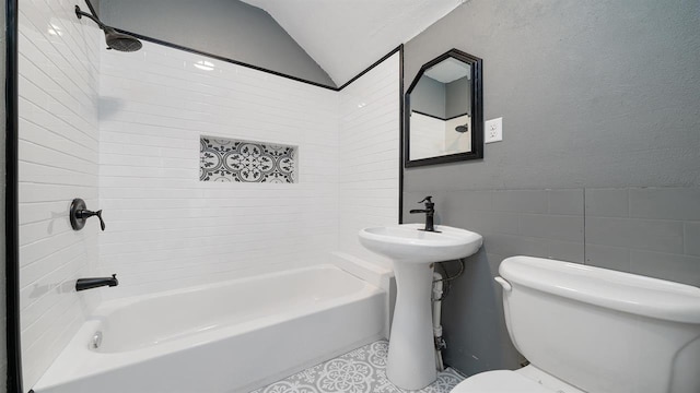 639 W Elk St, Freeport, IL 61032 - full bath with toilet, washtub / shower combination, tile walls, vaulted ceiling, and tile patterned floors