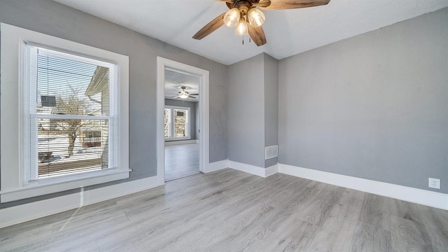 639 W Elk St, Freeport, IL 61032 - spare room featuring wood finished floors, baseboards, and a ceiling fan