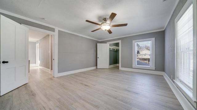 639 W Elk St, Freeport, IL 61032 - empty room with ceiling fan, ornamental molding, light wood-style floors, and baseboards