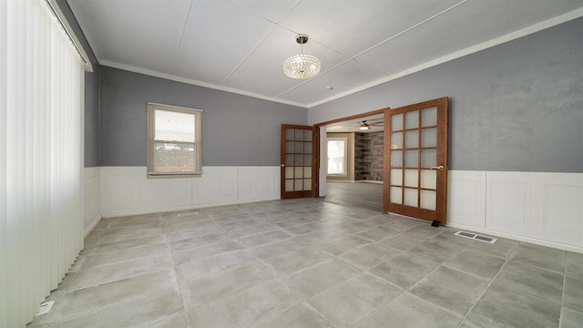 639 W Elk St, Freeport, IL 61032 - unfurnished room featuring plenty of natural light, a wainscoted wall, ceiling fan, and ornamental molding