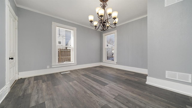 639 W Elk St, Freeport, IL 61032 - spare room featuring crown molding, a chandelier, healthy amount of natural light, dark wood-type flooring, and baseboards