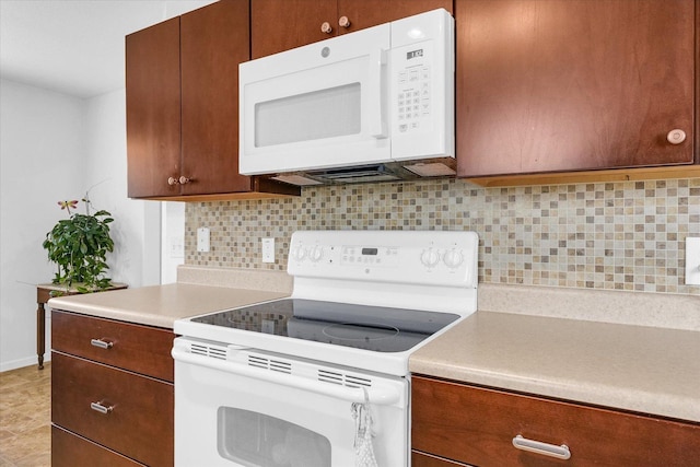 3407 Nobel Dr, Champaign, IL 61822 - kitchen with white appliances, light countertops, backsplash, and baseboards