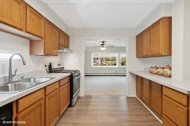 1137 Leavitt Ave Unit 118, Flossmoor, IL 60422 - kitchen with stainless steel gas stove, under cabinet range hood, ceiling fan, light countertops, and brown cabinetry
