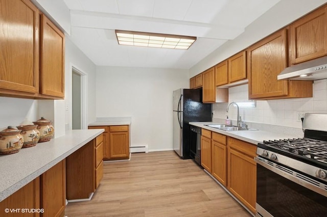 1137 Leavitt Ave Unit 118, Flossmoor, IL 60422 - kitchen with stainless steel gas stove, under cabinet range hood, light wood-style flooring, light countertops, and black dishwasher