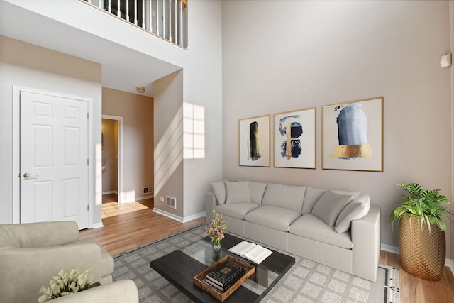 390 Jamestown Ct, Aurora, IL 60502 - living room featuring wood finished floors, baseboards, and a high ceiling