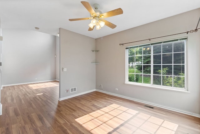 390 Jamestown Ct, Aurora, IL 60502 - unfurnished room with wood finished floors, a ceiling fan, and baseboards
