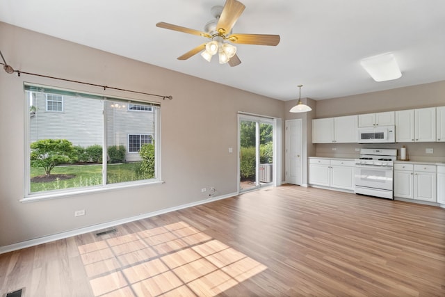390 Jamestown Ct, Aurora, IL 60502 - kitchen with white appliances, light countertops, white cabinetry, light wood-type flooring, and baseboards