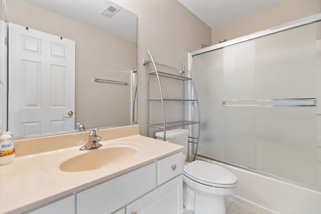 390 Jamestown Ct, Aurora, IL 60502 - bathroom featuring toilet, vanity, bath / shower combo with glass door, and tile patterned flooring