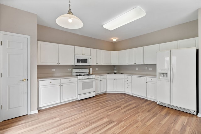 390 Jamestown Ct, Aurora, IL 60502 - kitchen with white appliances, light wood-style floors, a sink, light countertops, and white cabinets
