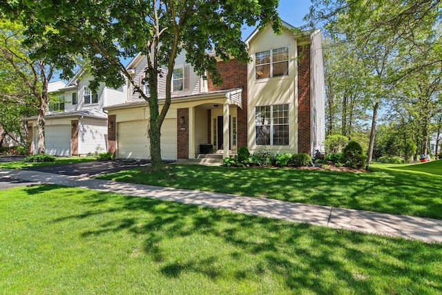 29644 N Birch Ave, Lake Bluff, IL 60044 - traditional home featuring brick siding, an attached garage, a front lawn, and asphalt driveway
