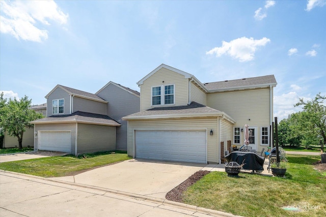 28 Waterbury Cir, Oswego, IL 60543 - traditional-style house with a fire pit, a front lawn, driveway, and a garage