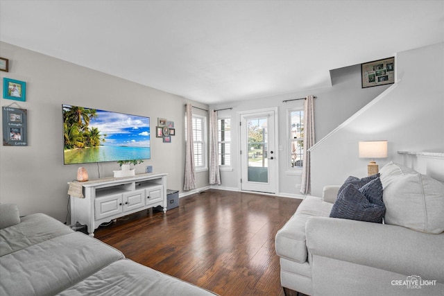 28 Waterbury Cir, Oswego, IL 60543 - living room featuring dark wood-style flooring and baseboards