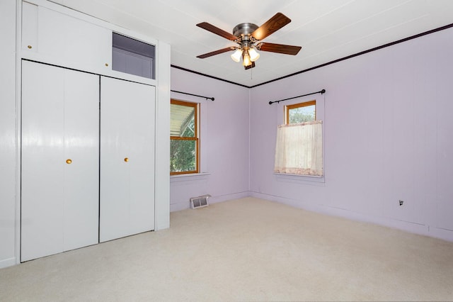424 Robinson St, Earlville, IL 60518 - unfurnished bedroom featuring carpet, a closet, and a ceiling fan