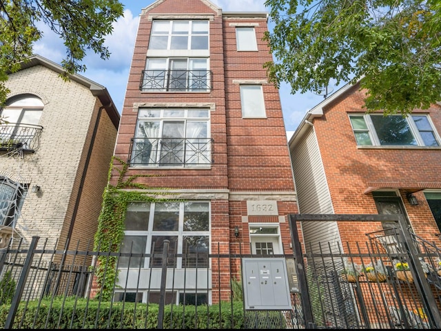 1632 W Erie St Unit 3, Chicago, IL 60622 - view of property featuring a fenced front yard and brick siding