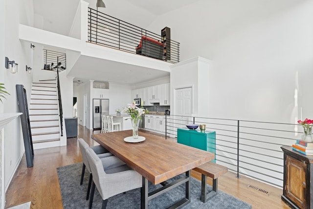 1632 W Erie St Unit 3, Chicago, IL 60622 - dining area featuring a high ceiling, light wood-type flooring, and stairway