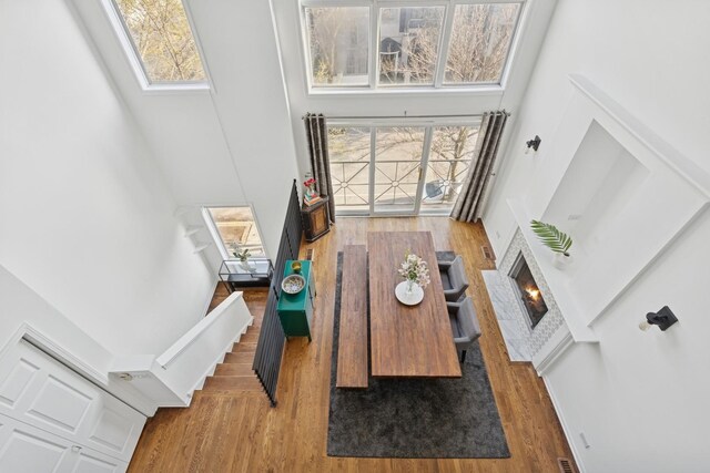 1632 W Erie St Unit 3, Chicago, IL 60622 - living area with a towering ceiling, wood finished floors, a brick fireplace, and plenty of natural light