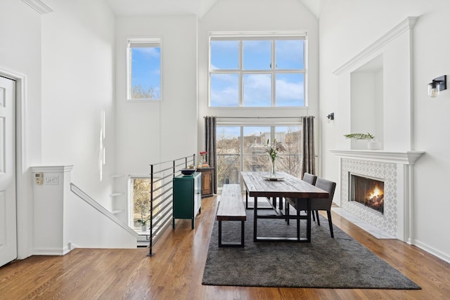 1632 W Erie St Unit 3, Chicago, IL 60622 - dining area featuring high vaulted ceiling, wood finished floors, and a tiled fireplace