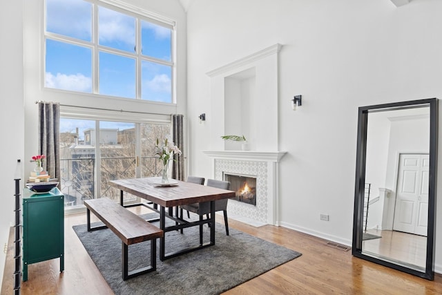 1632 W Erie St Unit 3, Chicago, IL 60622 - dining area featuring a high ceiling, a fireplace with flush hearth, and wood finished floors