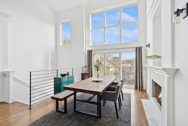 1632 W Erie St Unit 3, Chicago, IL 60622 - dining area featuring wood finished floors, healthy amount of natural light, a high end fireplace, and a towering ceiling
