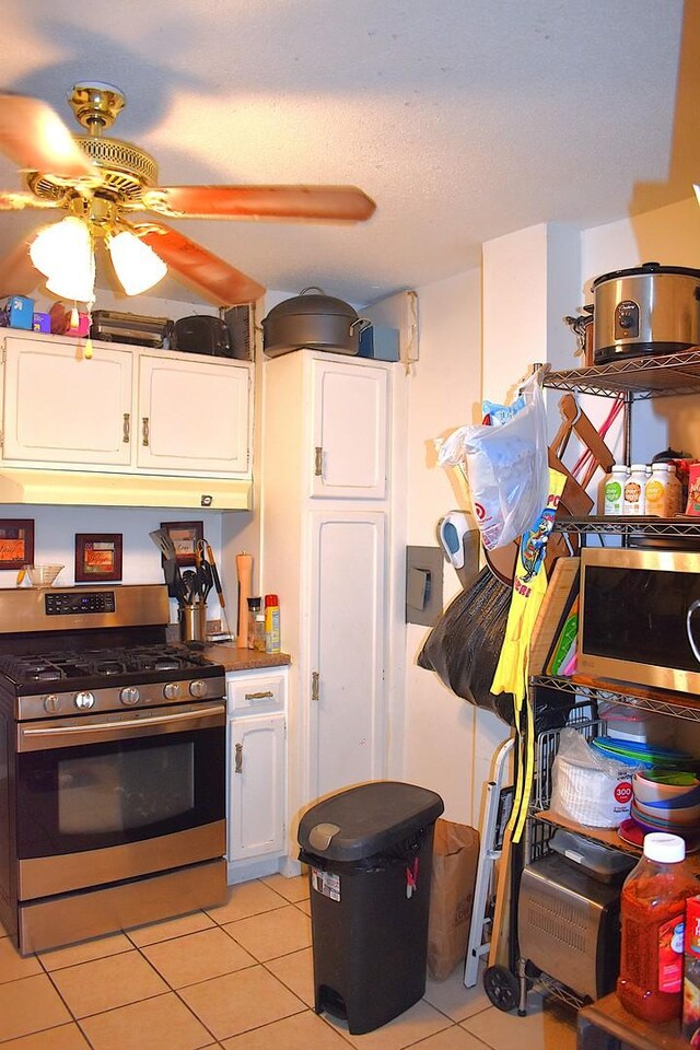 2201 S Stewart Ave Unit 5H, Lombard, IL 60148 - kitchen featuring stainless steel range with gas cooktop, white cabinetry, light tile patterned flooring, and a ceiling fan