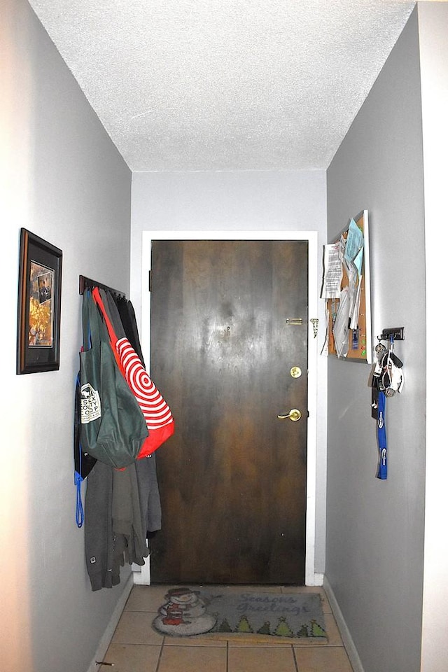 2201 S Stewart Ave Unit 5H, Lombard, IL 60148 - entryway with tile patterned floors, a textured ceiling, and baseboards