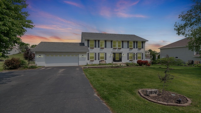 3894 E Whippoorwill Ln, Byron, IL 61010 - colonial home featuring driveway, a garage, and a lawn