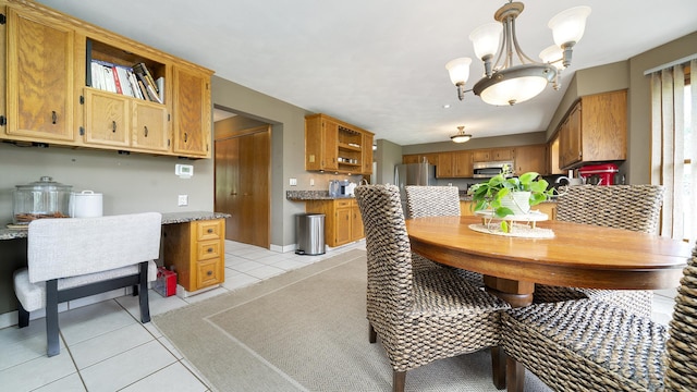 3894 E Whippoorwill Ln, Byron, IL 61010 - dining room with light tile patterned floors and a chandelier