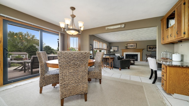 3894 E Whippoorwill Ln, Byron, IL 61010 - dining space with light colored carpet, light tile patterned floors, a chandelier, and a tile fireplace