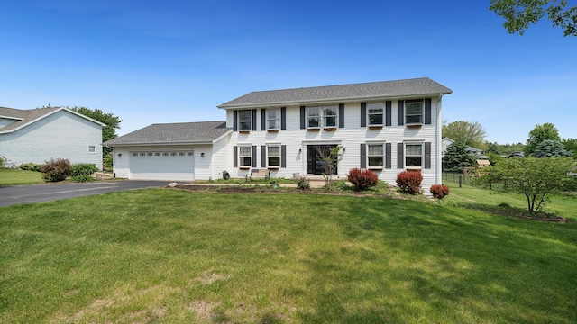 3894 E Whippoorwill Ln, Byron, IL 61010 - colonial home featuring asphalt driveway, an attached garage, and a front lawn