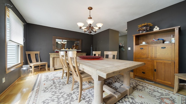 3894 E Whippoorwill Ln, Byron, IL 61010 - dining space with a chandelier, light wood-type flooring, and baseboards