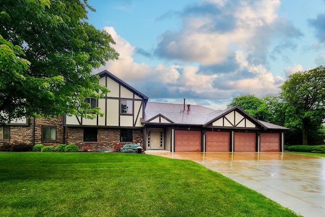 41 Brandywine Ct Unit 41, Bloomington, IL 61704 - tudor-style house featuring an attached garage, driveway, a front yard, and stucco siding