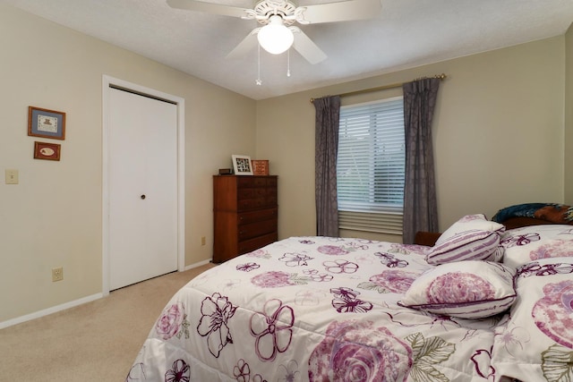41 Brandywine Ct Unit 41, Bloomington, IL 61704 - bedroom with light colored carpet, baseboards, ceiling fan, and a closet