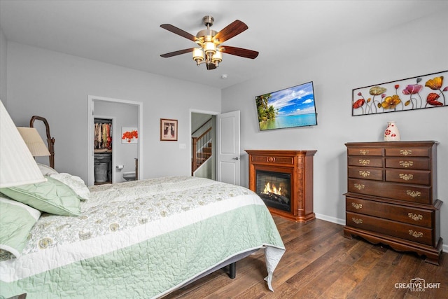 1285 Highpoint Ct, Bartlett, IL 60103 - bedroom with dark wood-type flooring, a glass covered fireplace, and a ceiling fan