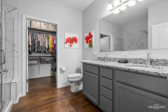 1285 Highpoint Ct, Bartlett, IL 60103 - bathroom with a stall shower, double vanity, wood finished floors, and a walk in closet