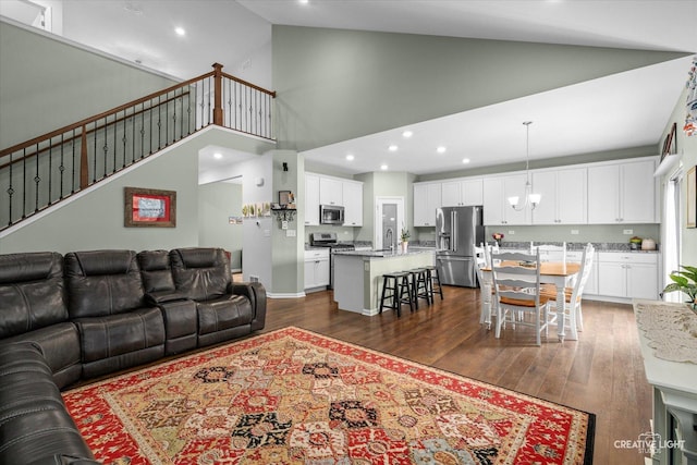 1285 Highpoint Ct, Bartlett, IL 60103 - living area featuring dark wood-style flooring, high vaulted ceiling, a chandelier, recessed lighting, and stairway