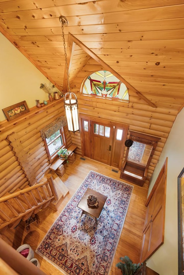10415 Ridge Ln, Huntley, IL 60142 - foyer entrance featuring log walls, high vaulted ceiling, wood ceiling, and light wood finished floors