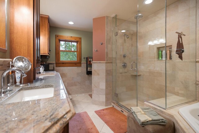 10415 Ridge Ln, Huntley, IL 60142 - full bathroom with a stall shower, tile patterned floors, tiled bath, double vanity, and tile walls