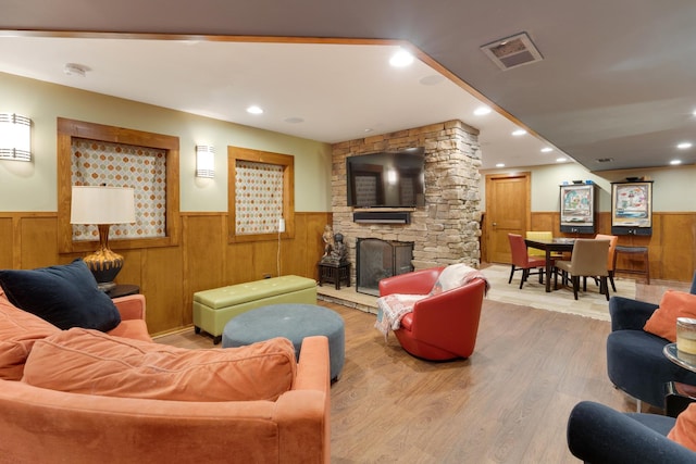 10415 Ridge Ln, Huntley, IL 60142 - living area featuring a wainscoted wall, a stone fireplace, wood finished floors, recessed lighting, and wooden walls