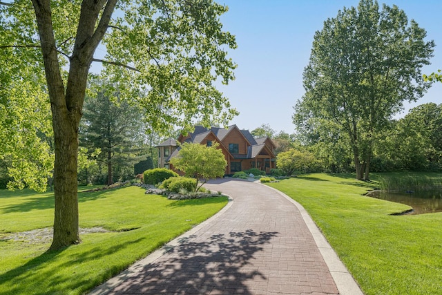 10415 Ridge Ln, Huntley, IL 60142 - view of front of house featuring a front lawn, a water view, and driveway