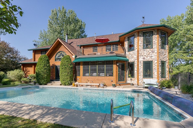 10415 Ridge Ln, Huntley, IL 60142 - back of house featuring a balcony, an outdoor pool, entry steps, and stone siding