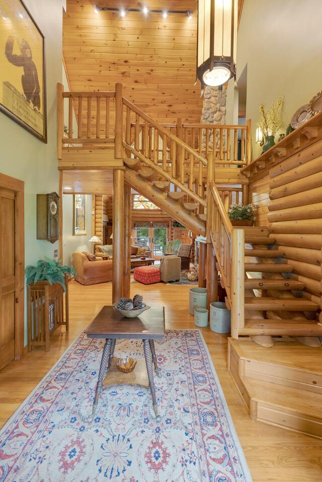 10415 Ridge Ln, Huntley, IL 60142 - living area featuring a towering ceiling, log walls, stairs, and wood finished floors