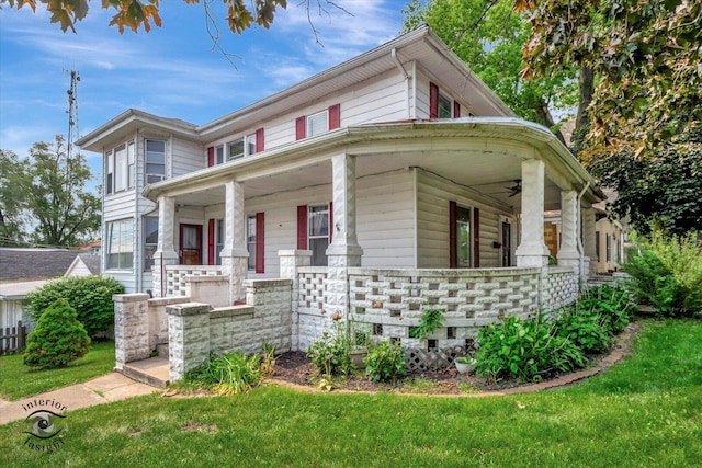 116 N Kankakee St, Wilmington, IL 60481 - view of front of house with covered porch, ceiling fan, a front yard, and stone siding