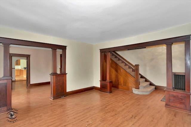 116 N Kankakee St, Wilmington, IL 60481 - below grade area with wood finished floors, baseboards, stairway, and arched walkways