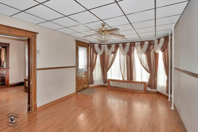 116 N Kankakee St, Wilmington, IL 60481 - unfurnished room with radiator, baseboards, wood finished floors, and a drop ceiling