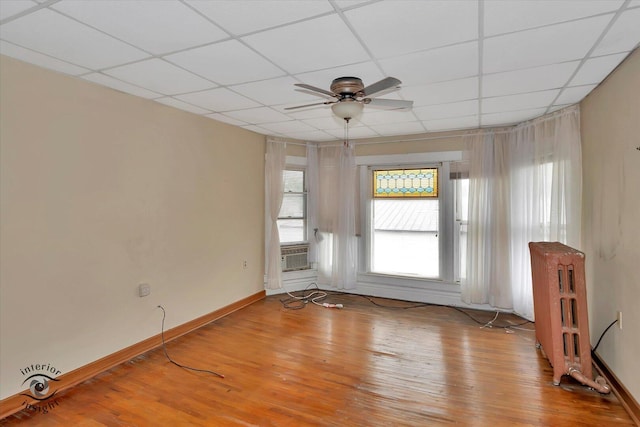 116 N Kankakee St, Wilmington, IL 60481 - unfurnished room featuring ceiling fan, light wood-style floors, a drop ceiling, baseboards, and cooling unit