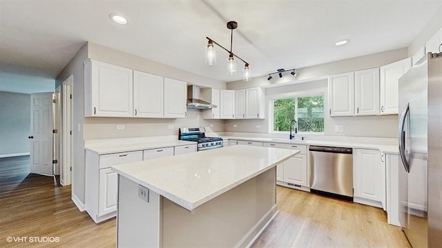 4622 Schwartz Ave, Lisle, IL 60532 - kitchen featuring appliances with stainless steel finishes, wall chimney range hood, light wood-style flooring, white cabinetry, and recessed lighting